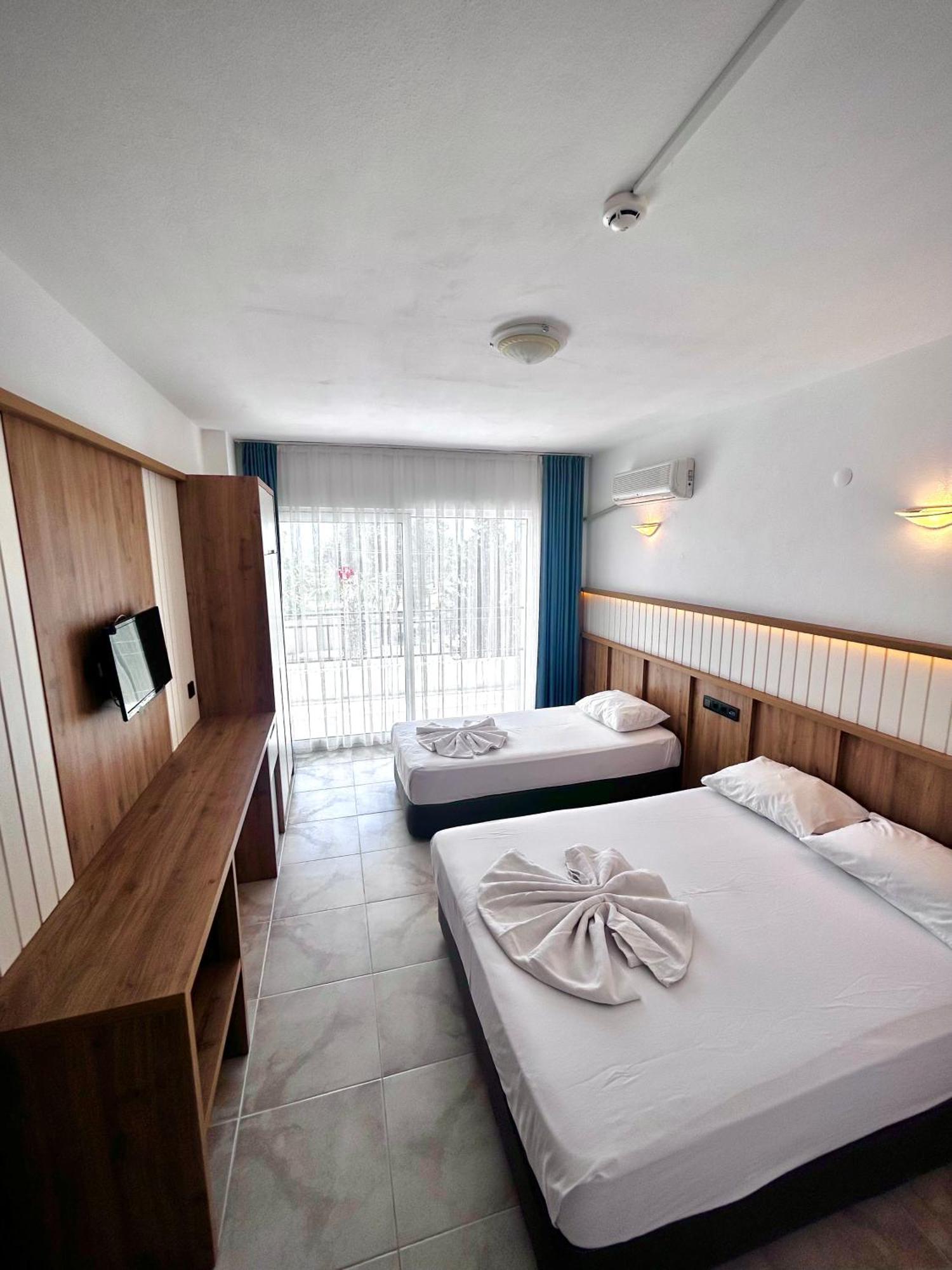 Tunan Motel Айвалык Номер фото